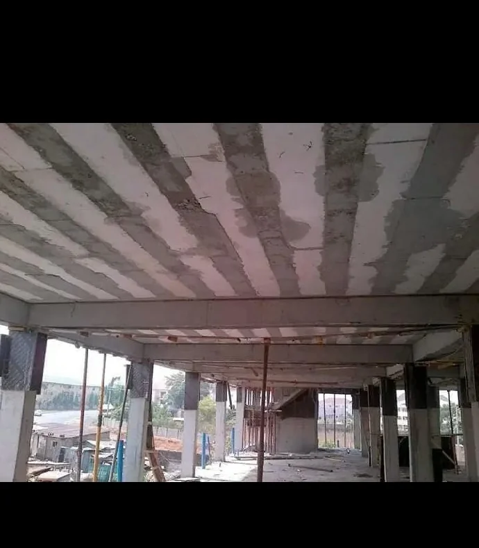 Construction workers applying spray foam insulation on a building site